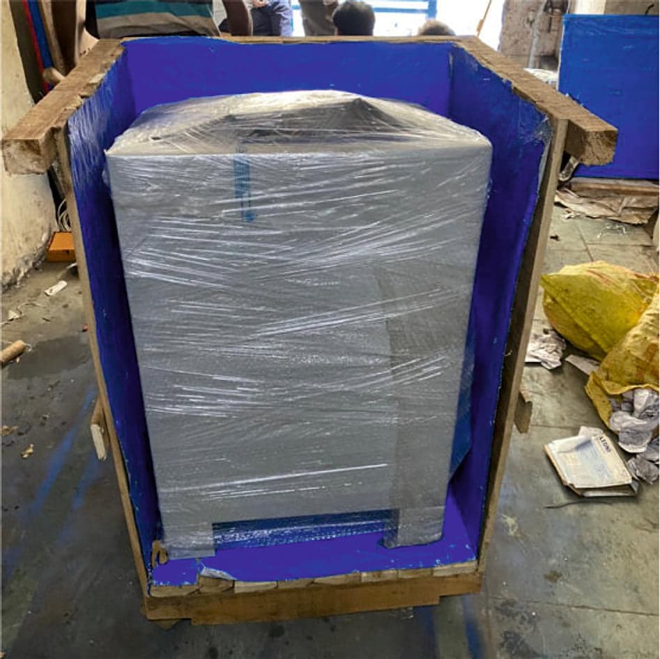 Machine shrink-wrapped inside a lined wooden export crate